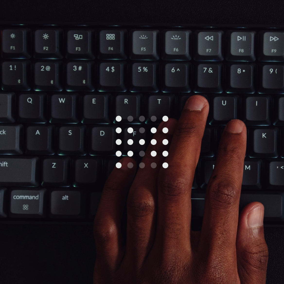 A close-up of a hand typing on a keyboard