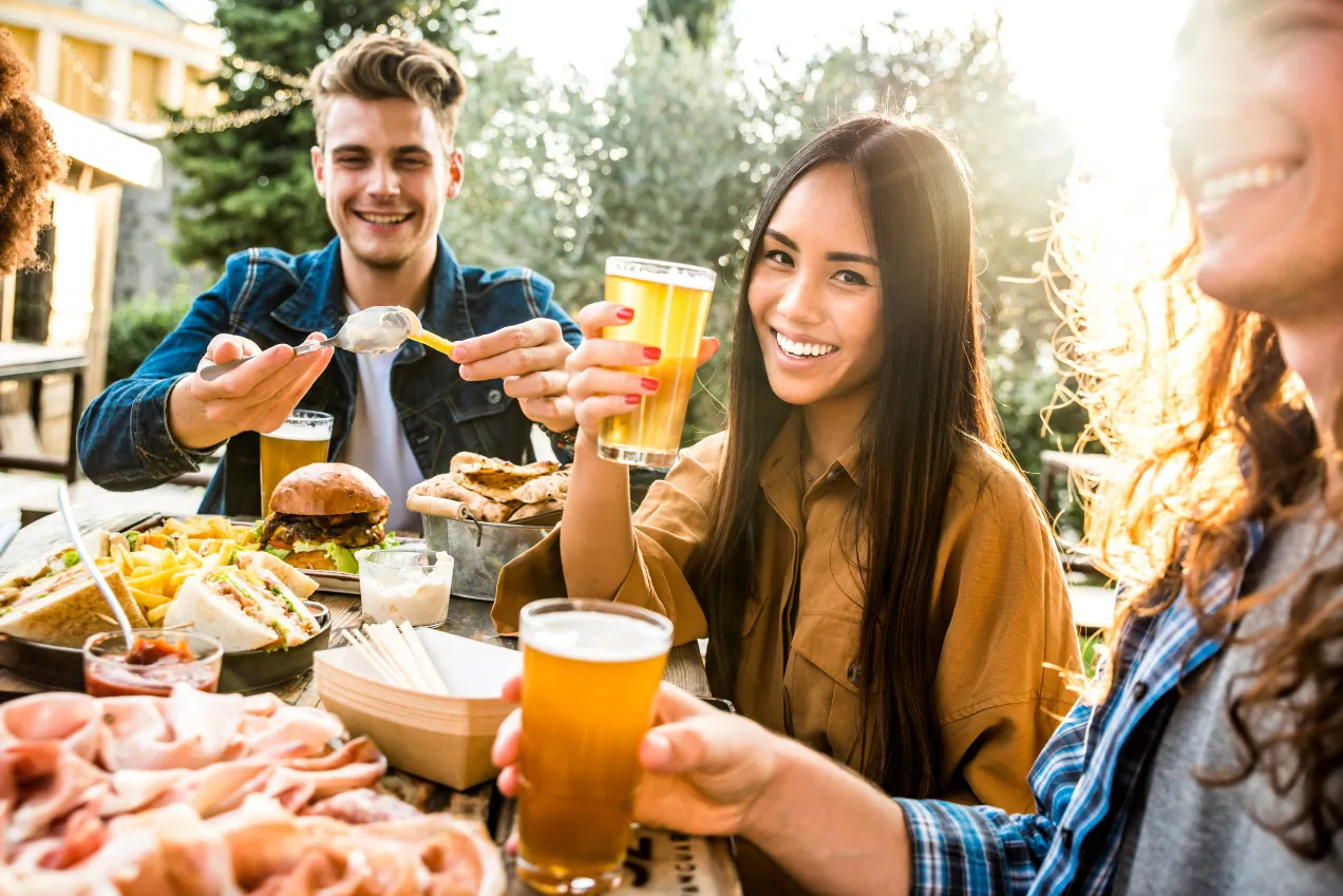 people gathered with food and drinks stock image