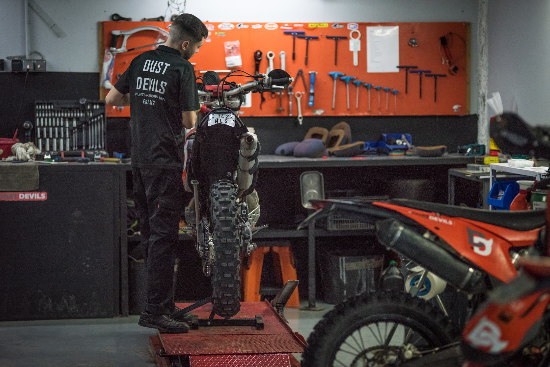 Image of mechanic servicing bikes