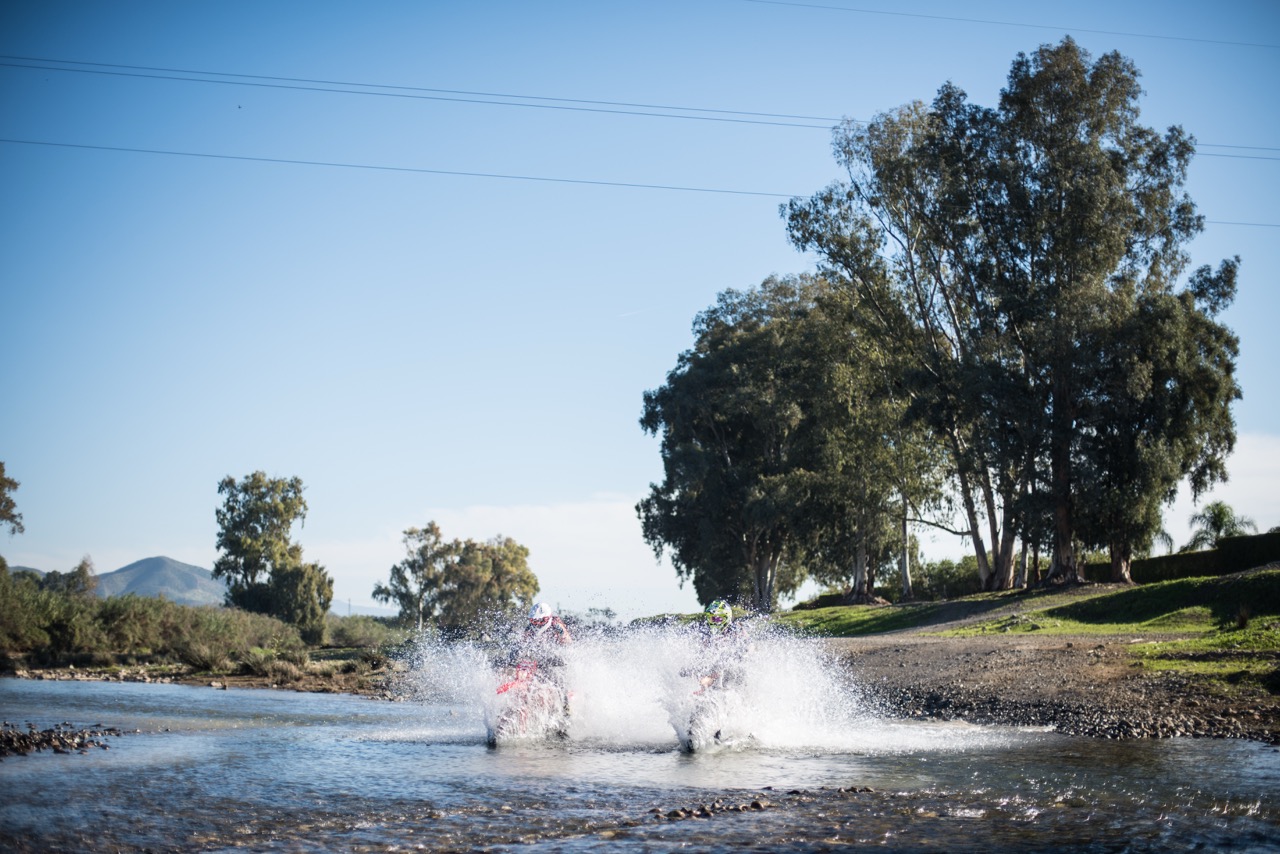 Motorcyles crashing through water