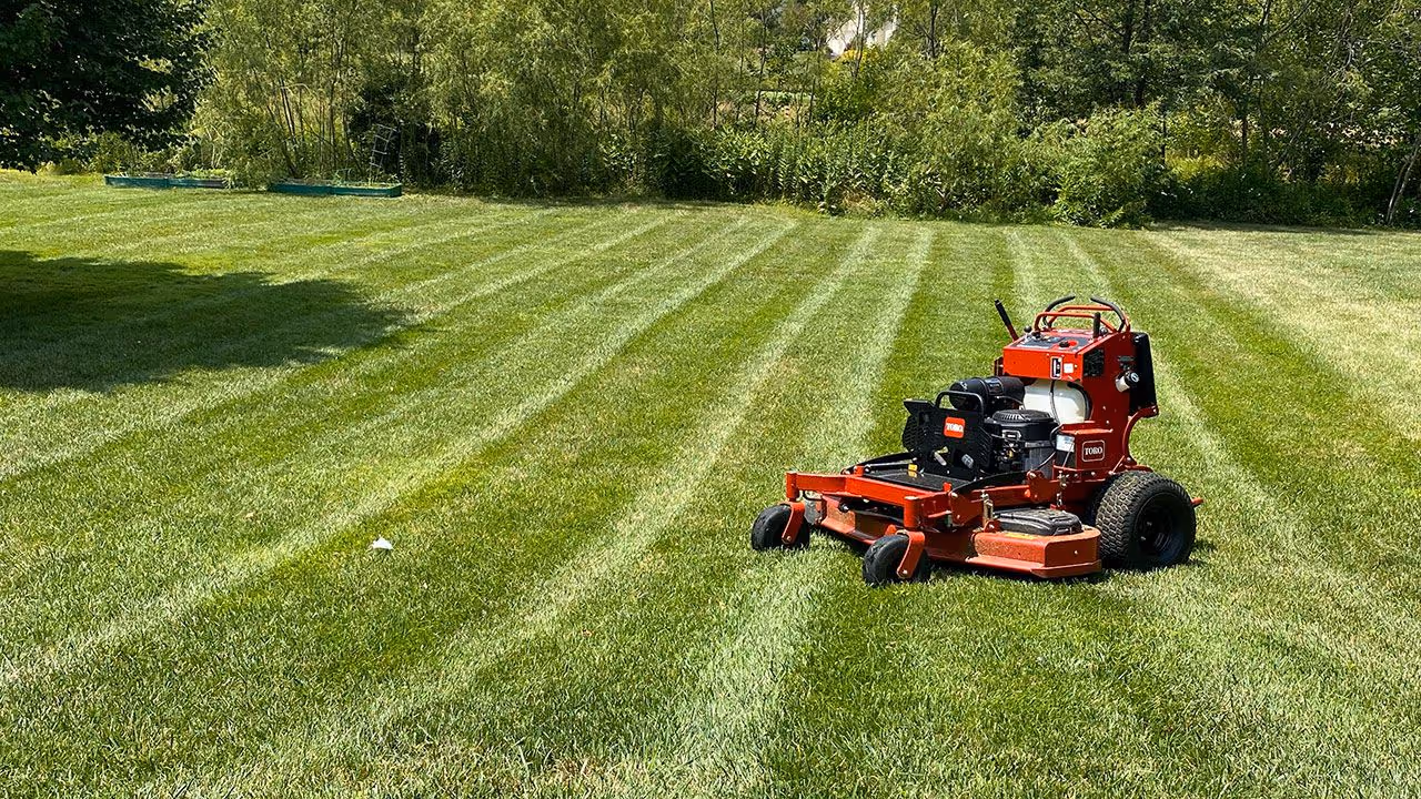 Commercial mower in action by PerfaCut Lawn and Landscape