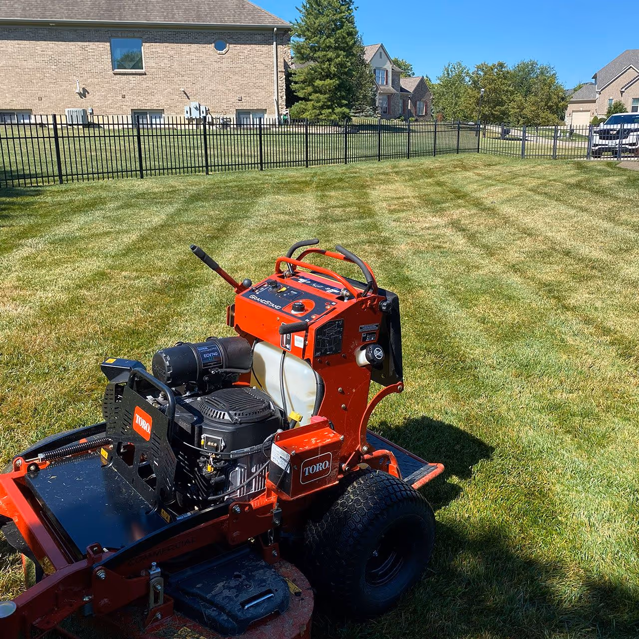 Commercial grade mower cutting residential lawn