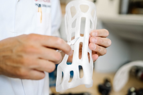 Custom made orthoses printed on a 3D printer being corrected by a orthopedist