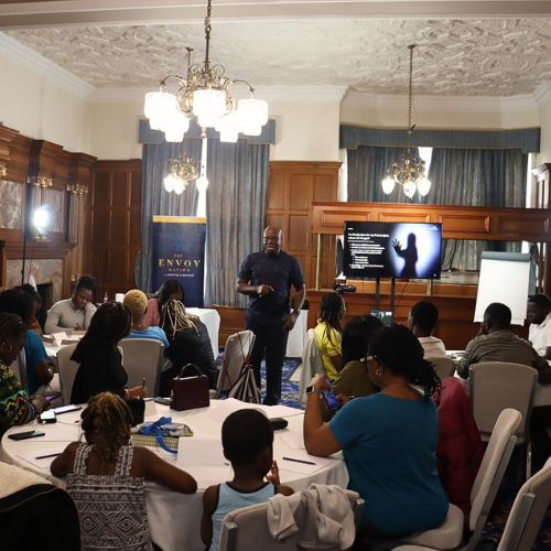 Blurred close-up of a bed with light green sheets.