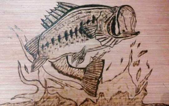 Woodburn art of a largemouth bass jumping out with splashes and smaller fish around it.