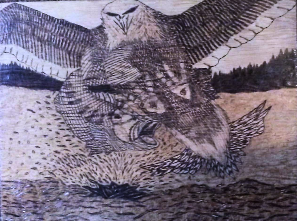 Wood carving of an eagle diving to catch a fish in water with forest in background.