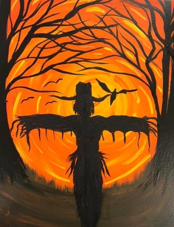 Silhouette of a scarecrow with birds in front of an orange glowing sunset behind bare trees.