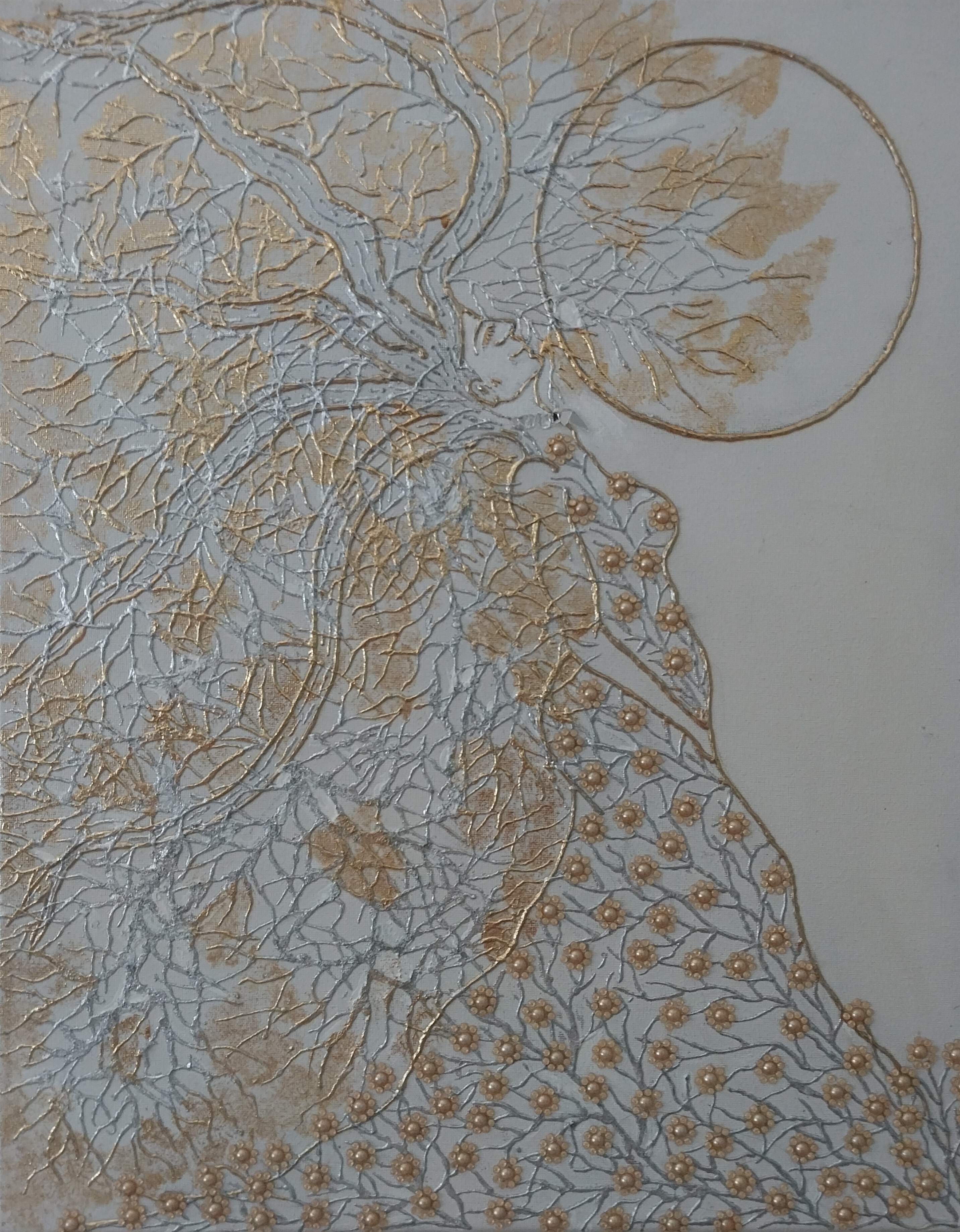 Abstract metallic artwork of a woman with flowing hair merging into branches and flowers.