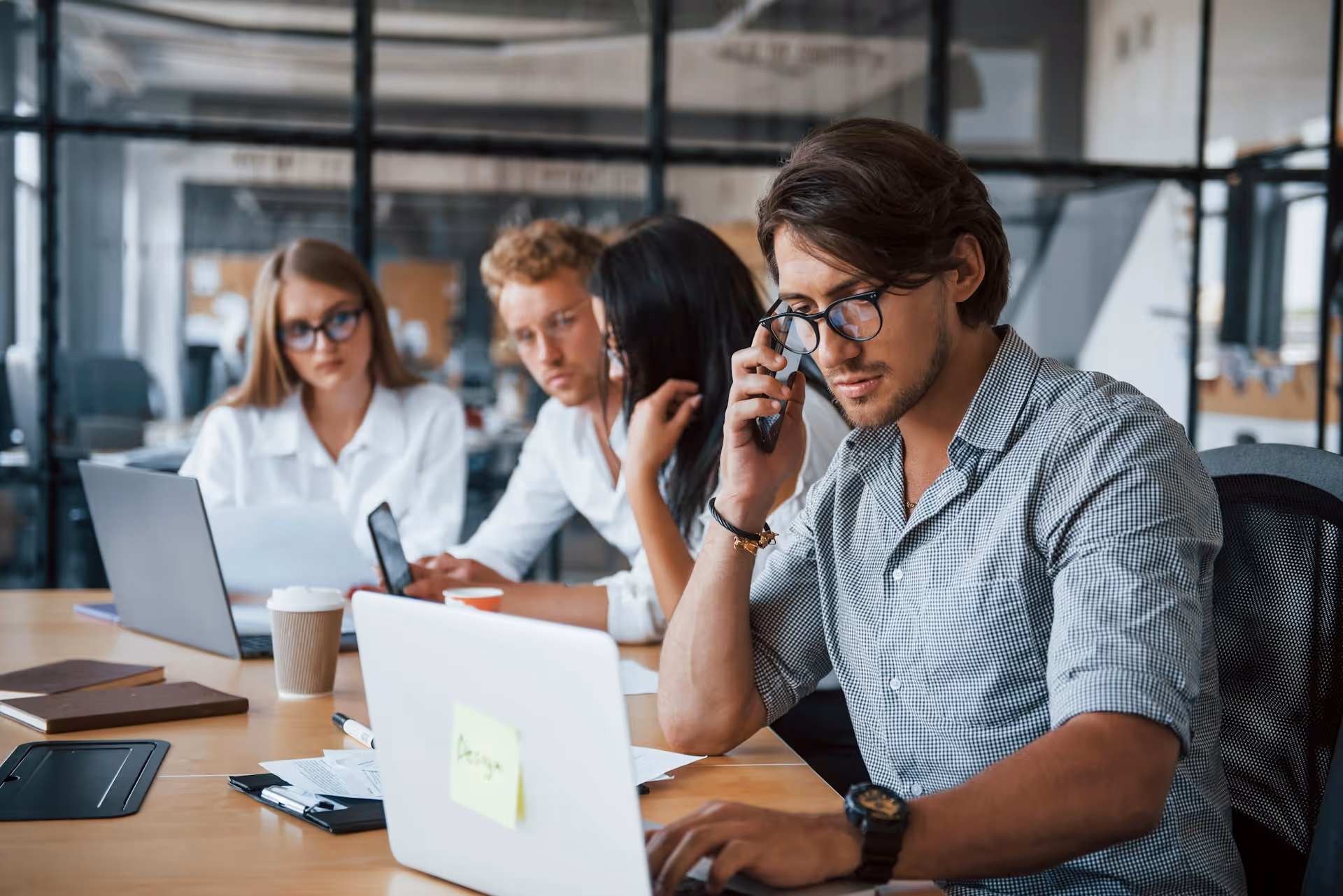 Professional working on laptop in modern office environment.