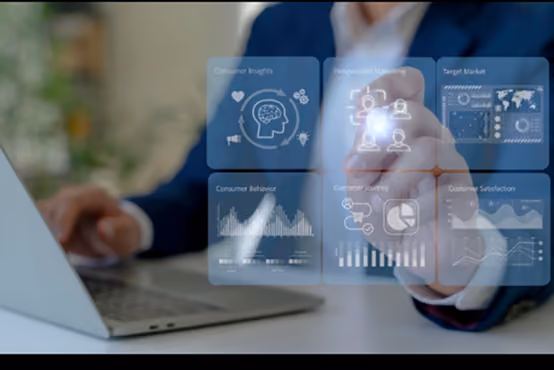 Person using laptop and interacting with floating business data and analytics icons.