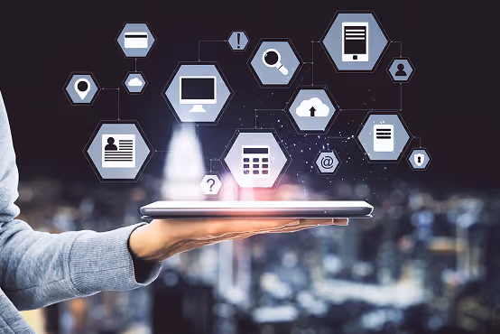 Hand holding a tablet with floating digital icons representing technology and communication.