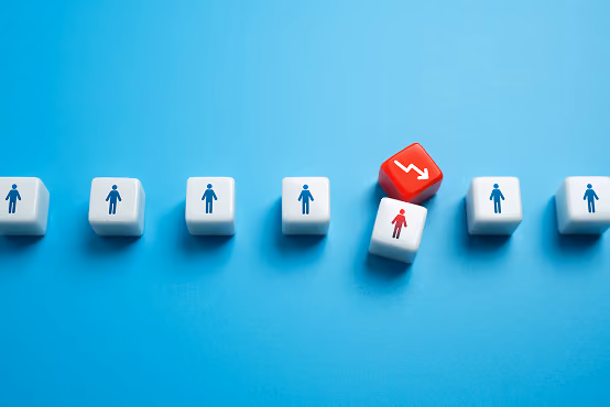 White dice with blue person icons in line, one red die with downward arrow and red person icon.