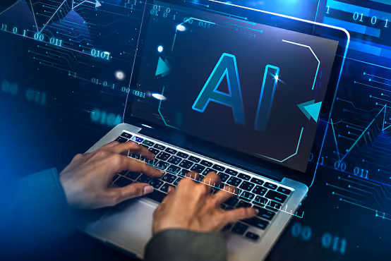 Person typing on laptop keyboard with a digital AI symbol glowing on the screen.