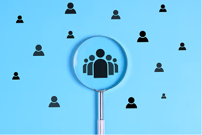 Magnifying glass highlighting a group of black person icons on a blue background.