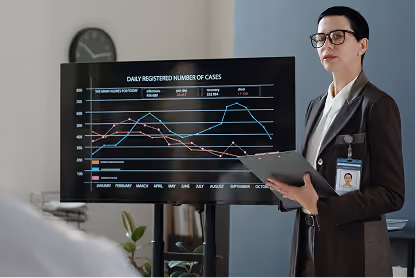 Professional woman holding tablet presents daily registered COVID-19 cases graph on screen.