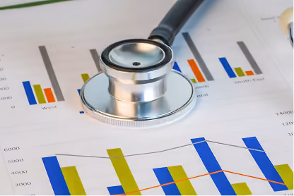 Stethoscope resting on papers with colorful bar charts and line graphs, representing health data.