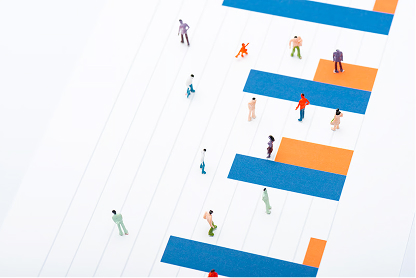 Miniature figurines placed on an abstract, striped chart with orange and blue bars.
