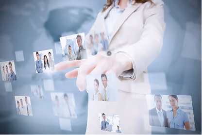 Businesswoman in beige suit interacting with floating transparent screens showing business team photos.