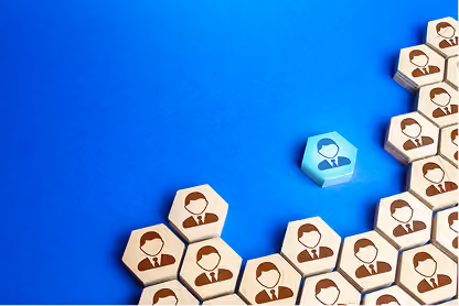 Single blue wooden block with business icon stands out among multiple beige blocks with similar icons on blue background.