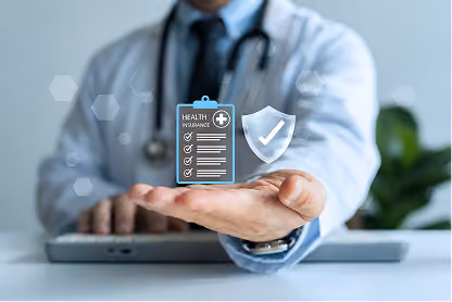 Doctor holding virtual icons of health insurance checklist and shield with checkmark.