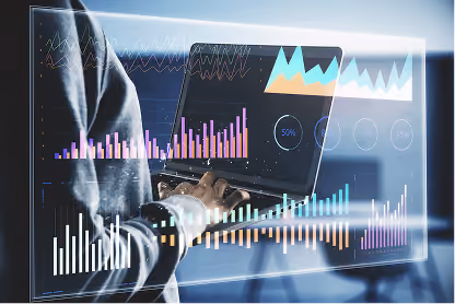 Person working on laptop displaying digital financial charts, graphs, and data overlays.