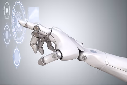 Robot hand with metallic fingers interacting with virtual futuristic interface in gray background.