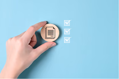 Hand holding wooden token with document icon next to three checkmarks on blue background.