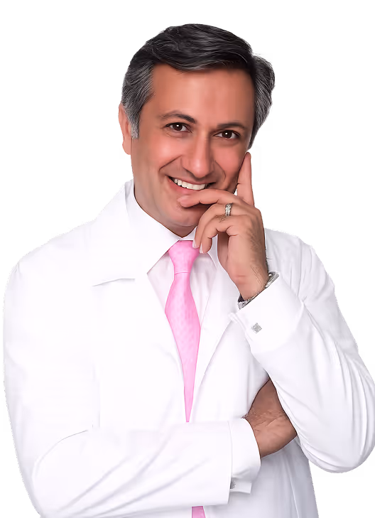 Smiling male doctor in white coat and pink tie with hand touching face.