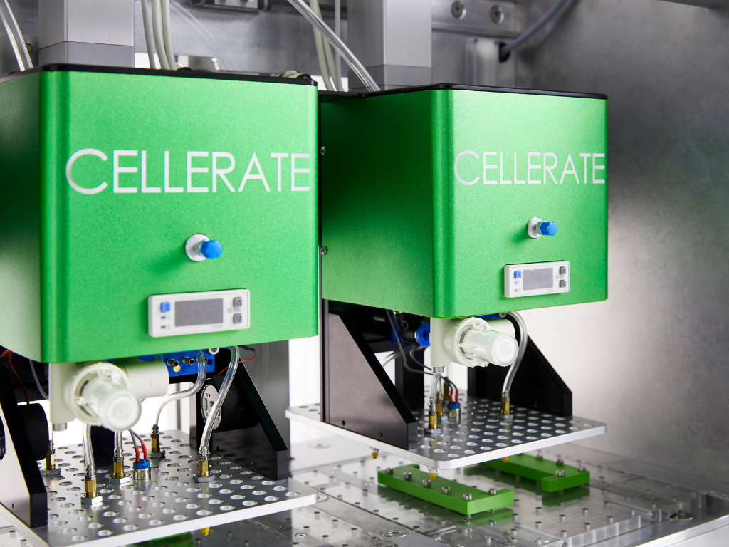 Two green CELLERATE laboratory devices mounted inside a metal enclosure with visible tubes and connectors.
