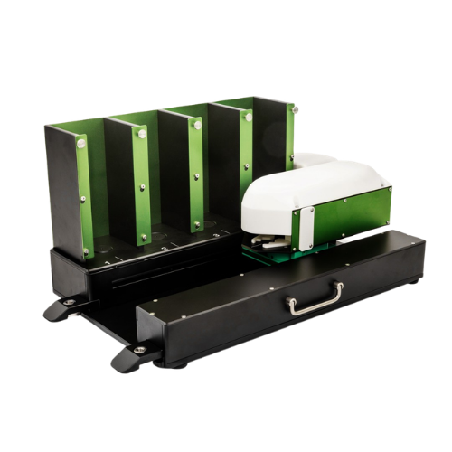 Automated laboratory autoloader device with four vertical green and black slots for holding samples and a white and green mechanical arm on a black base with a handle.