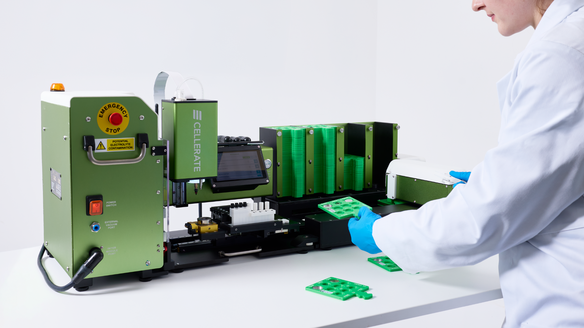 Green and white Cellerate machine for full cell assembly and sealing with touchscreen and control buttons.