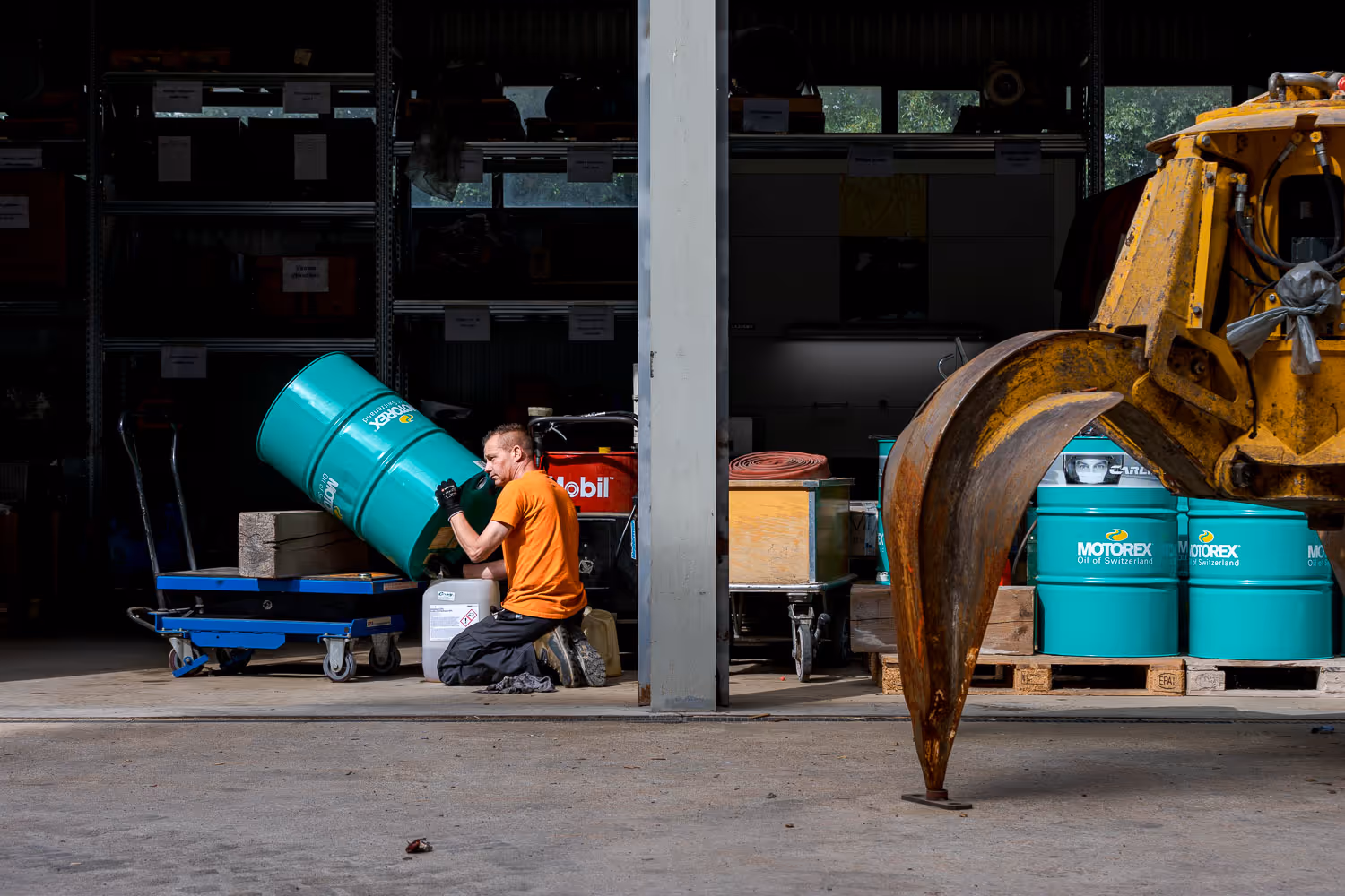 Photo reportage d'un employer d'ENEVI qui vide un bidon motorex 