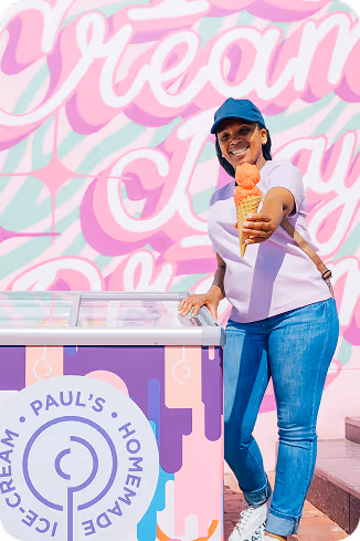 Black signboard mounted on a pole displaying the Tecbot logo and website tecbot.co.za along a street with parked cars and buildings in the background.