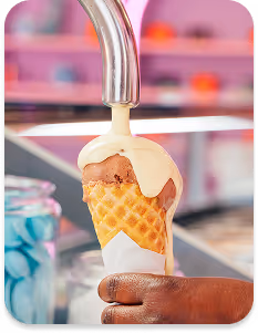 Cozy pink corner with white and pink chairs and tables, featuring four framed art prints on the walls.