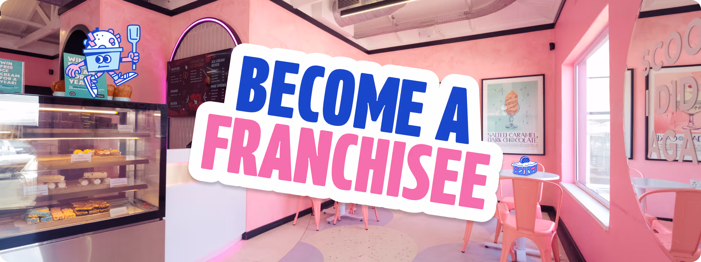 Smiling person standing next to a colorful three-wheeled ice cream cart with 'Paul's Homemade Ice Cream' logo in front of a pink mural.