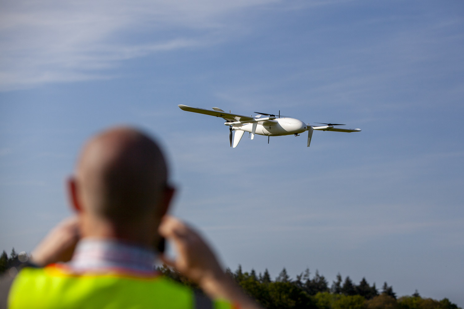 Drone operator monitoring a drone in flight