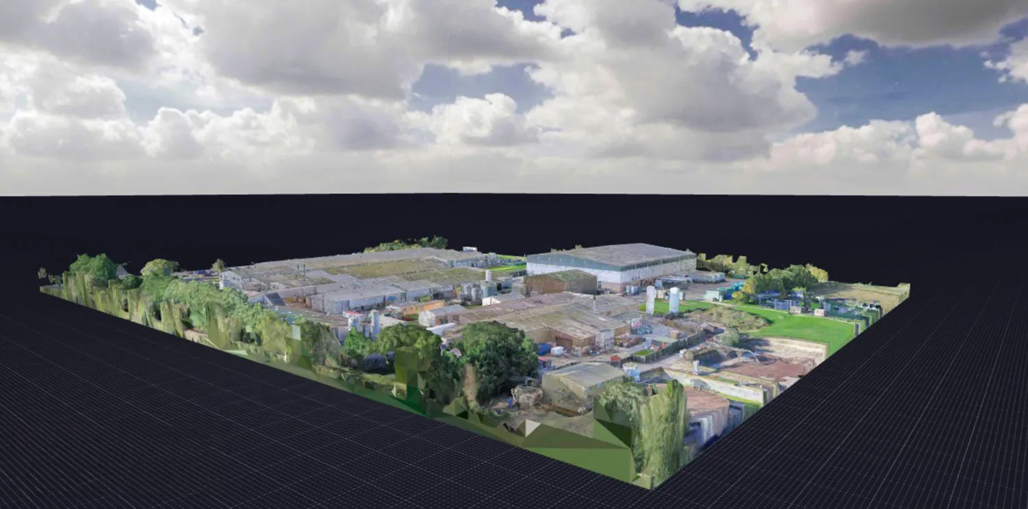 3D digital model of an industrial plant with buildings, tanks, and surrounding greenery under a partly cloudy sky.