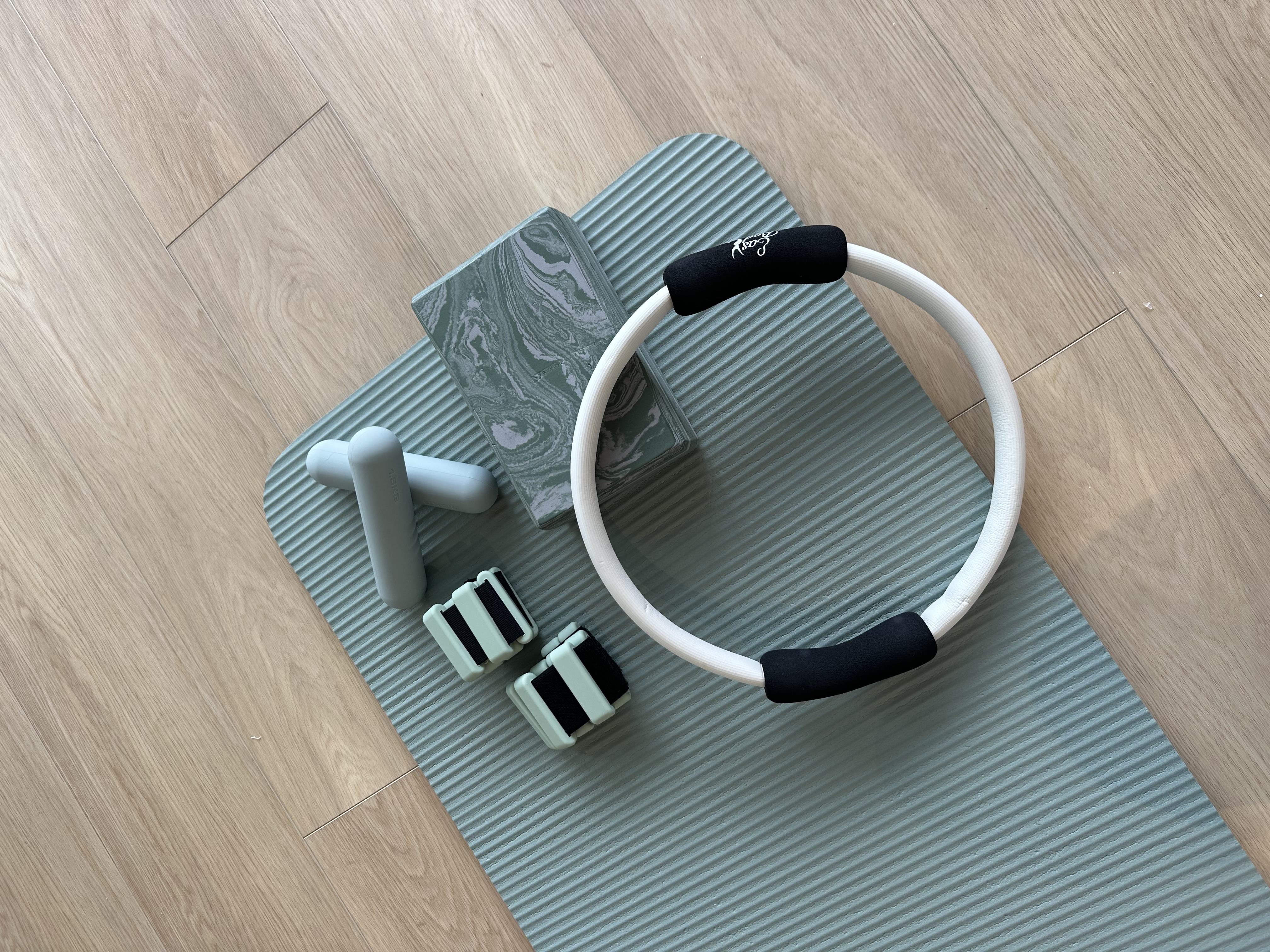 Woman in blue workout outfit doing a side plank on a yoga mat indoors.