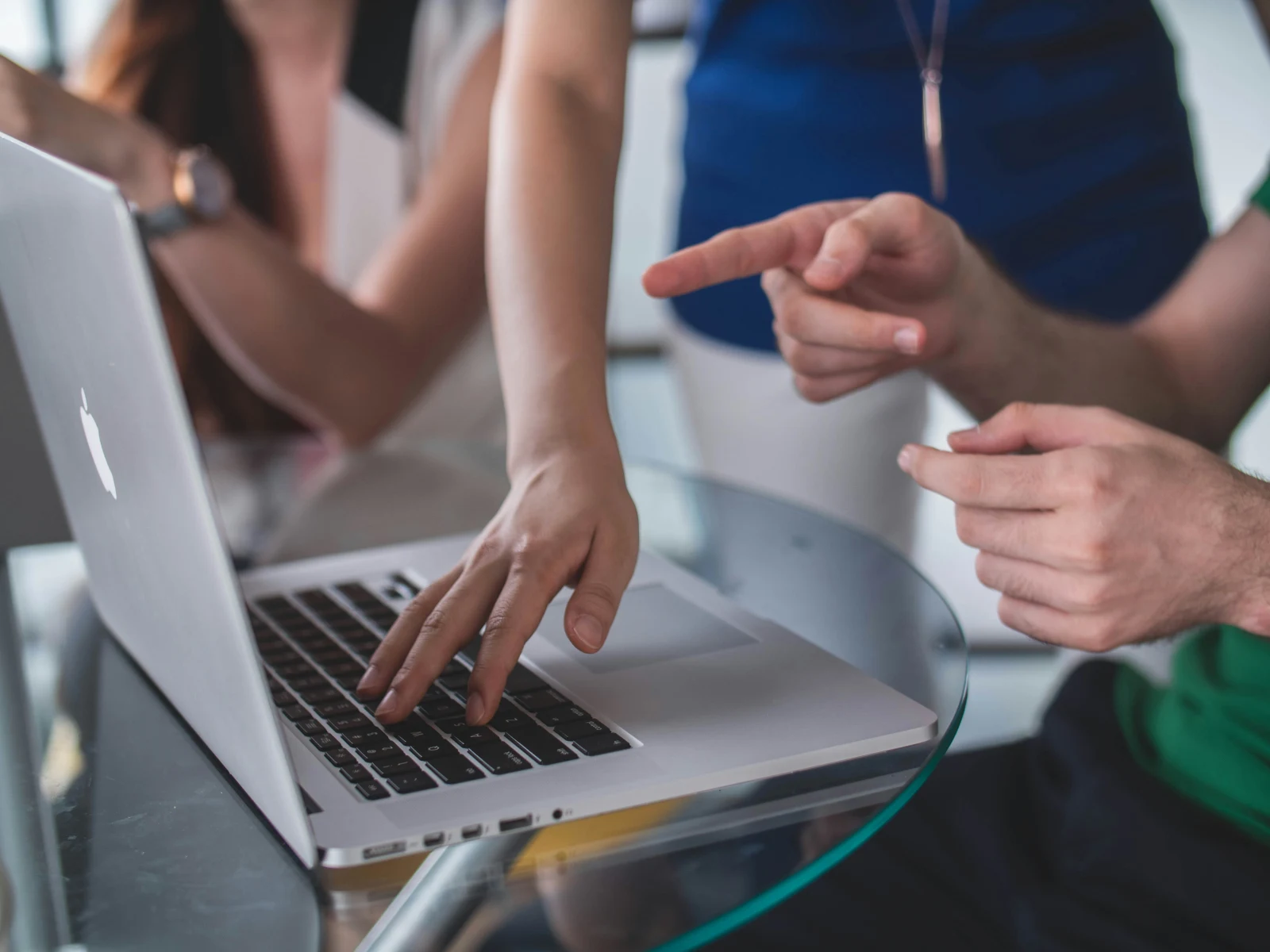 Équipe d'entreprise comparant des options de réservation de voyage sur un ordinateur portable