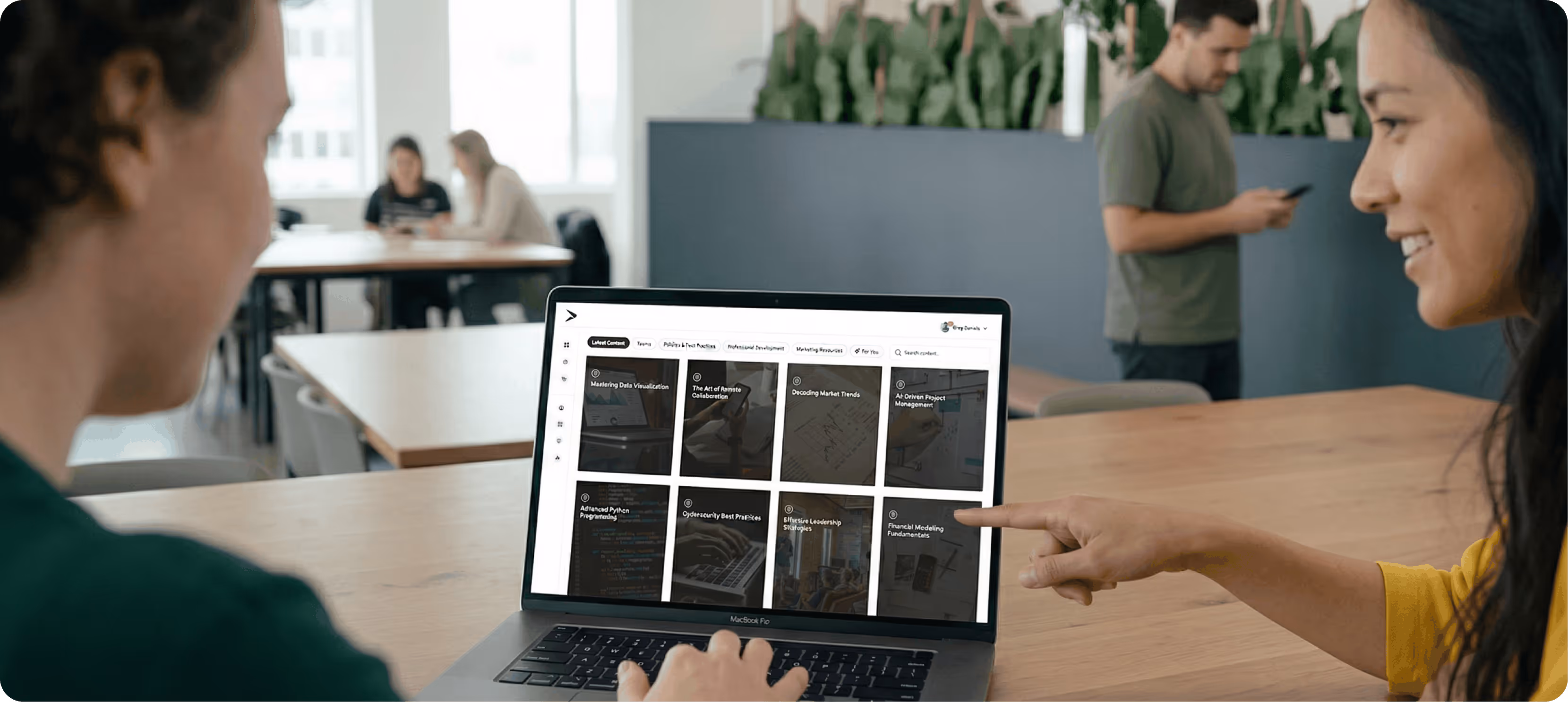 Employees in a modern office taking training on Continu.