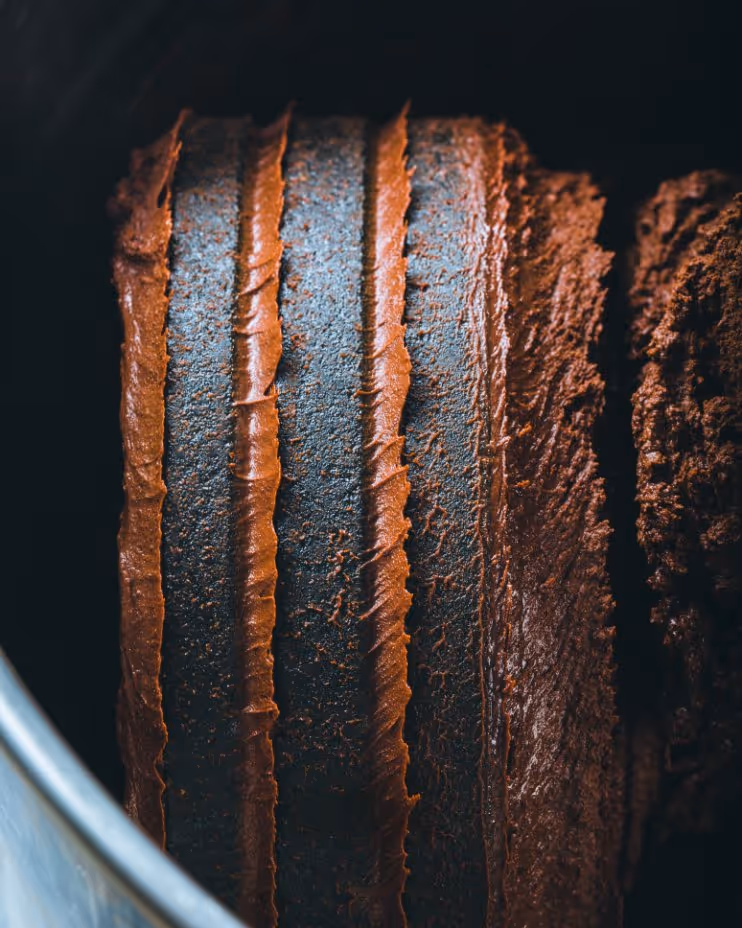 Close-up of a dirty tire with brown mud caked between the tread grooves.