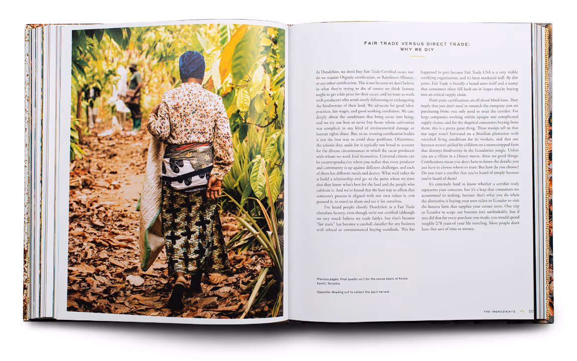 Open book showing a photo of a person walking through a cacao farm on the left, and text discussing fair trade versus direct trade on the right.