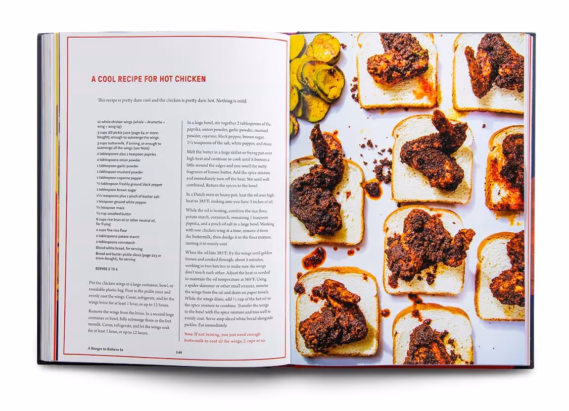 Open cookbook showing a recipe titled 'A Cool Recipe for Hot Chicken' on the left page and several pieces of fried hot chicken on white bread slices on the right page.