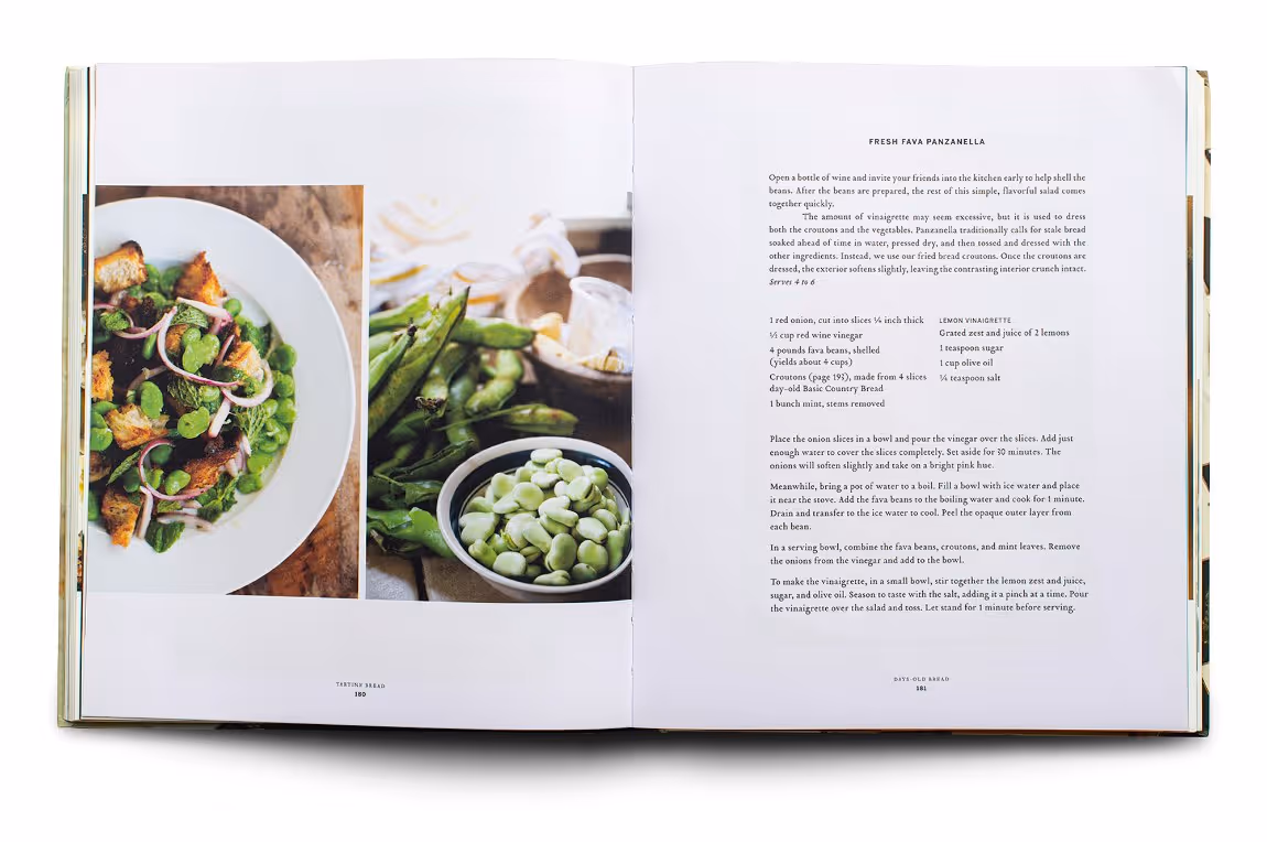 Open cookbook showing a fresh fava panzanella salad recipe with photos of the salad and fresh fava beans in pods and bowl.