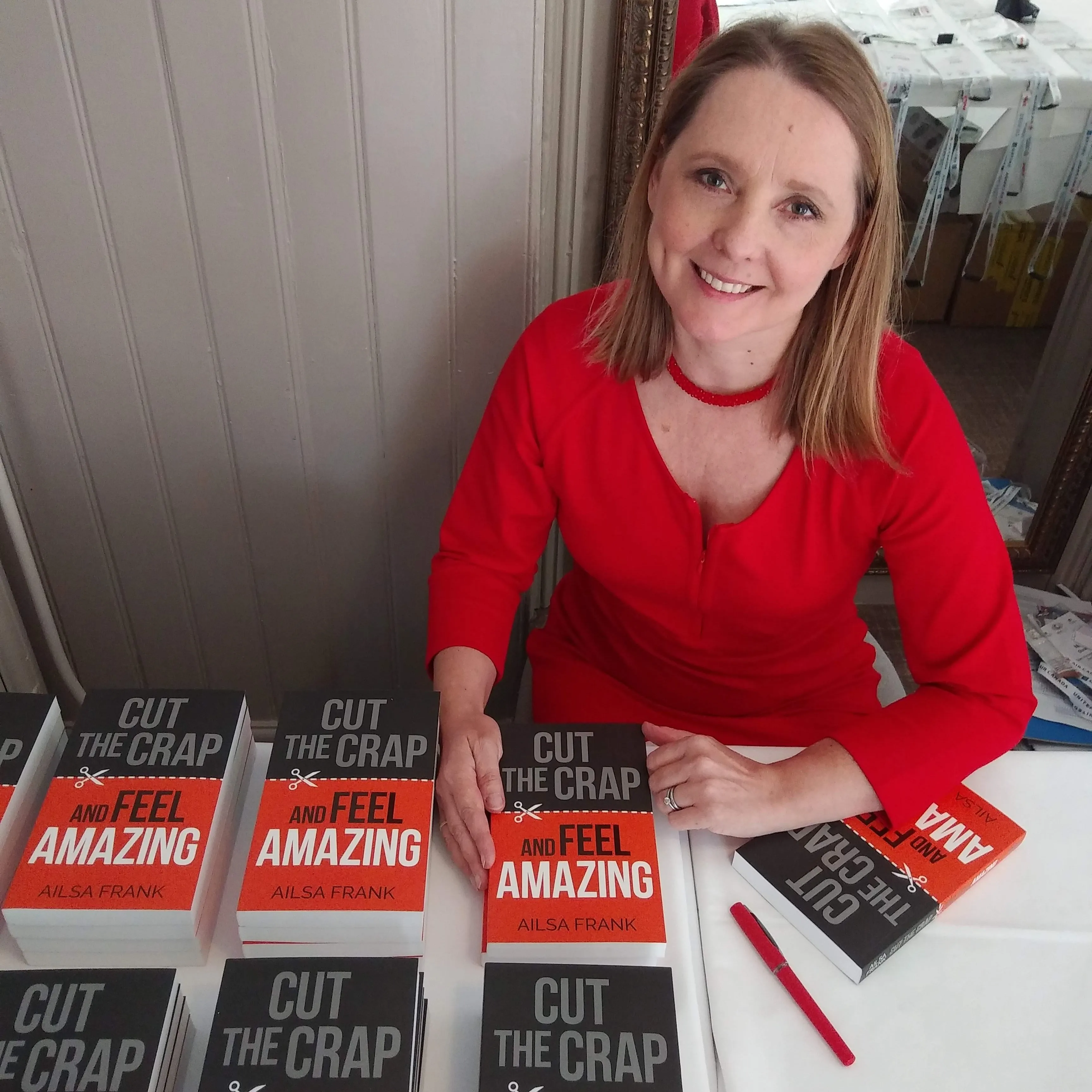 Ailsa Frank signing copies of Cut the Crap and Feel Amazing at an event