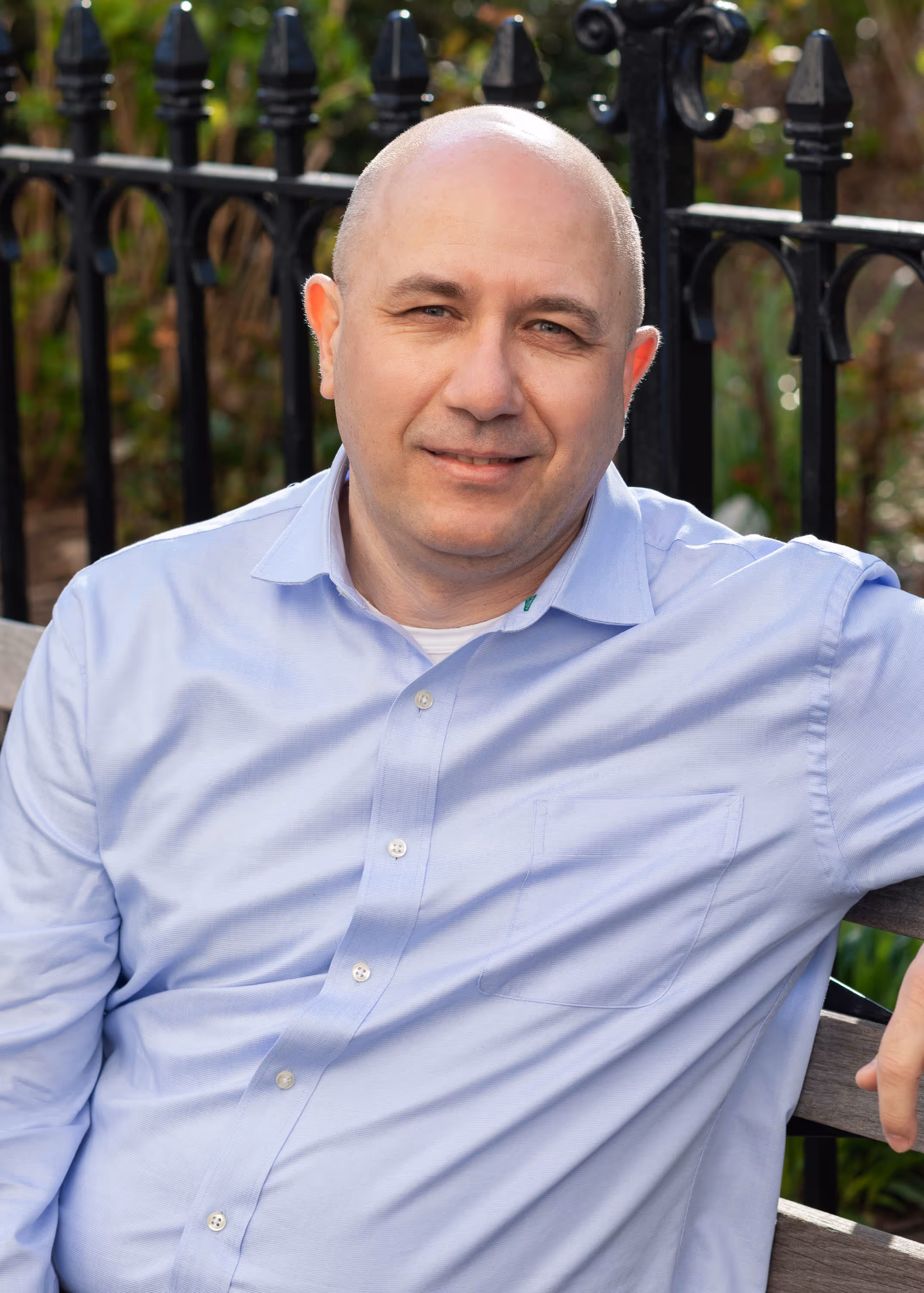 Smiling IT professional seated on bench outdoors, representing Point MSP's friendly managed services team in New York City