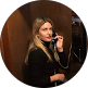 Woman speaking on a telephone handset in a professional office setting, providing business IT support services