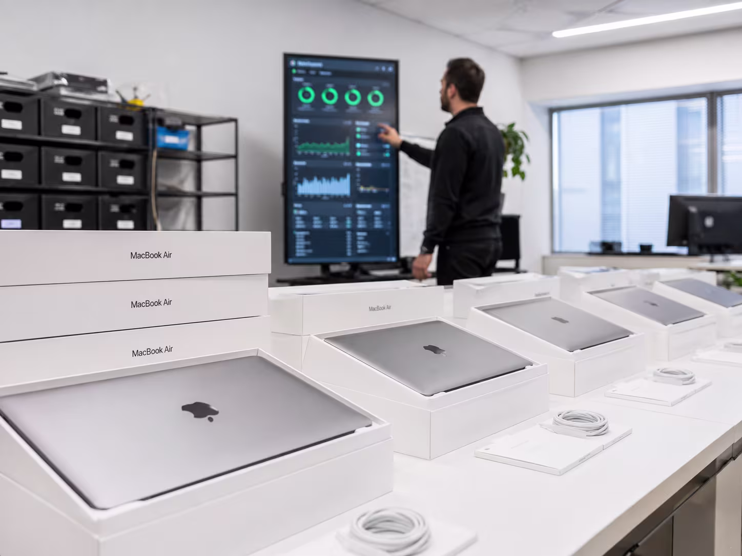 IT professional examining Apple MacBook