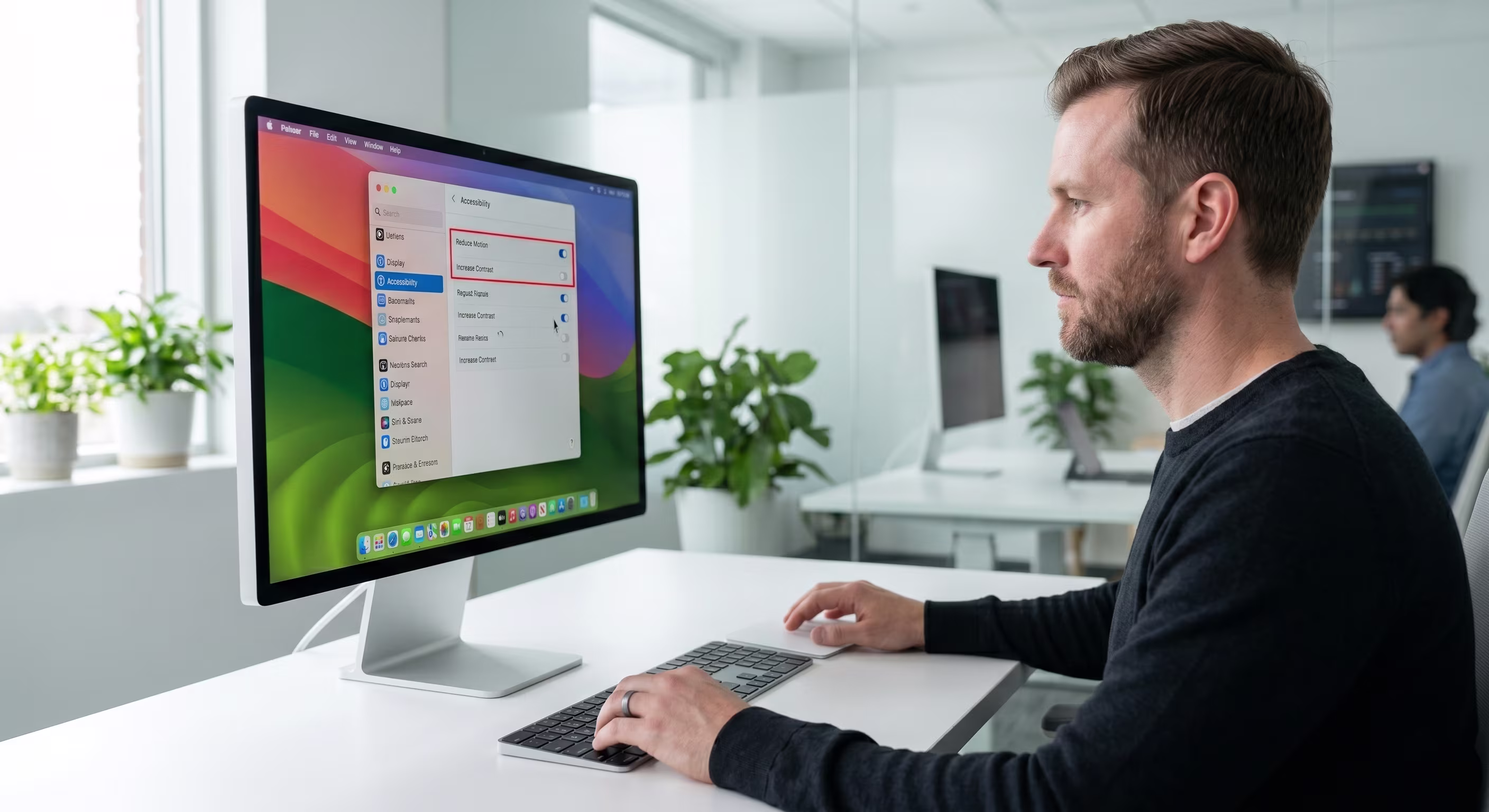 IT consultant providing Apple device setup and training for employees in a collaborative workplace