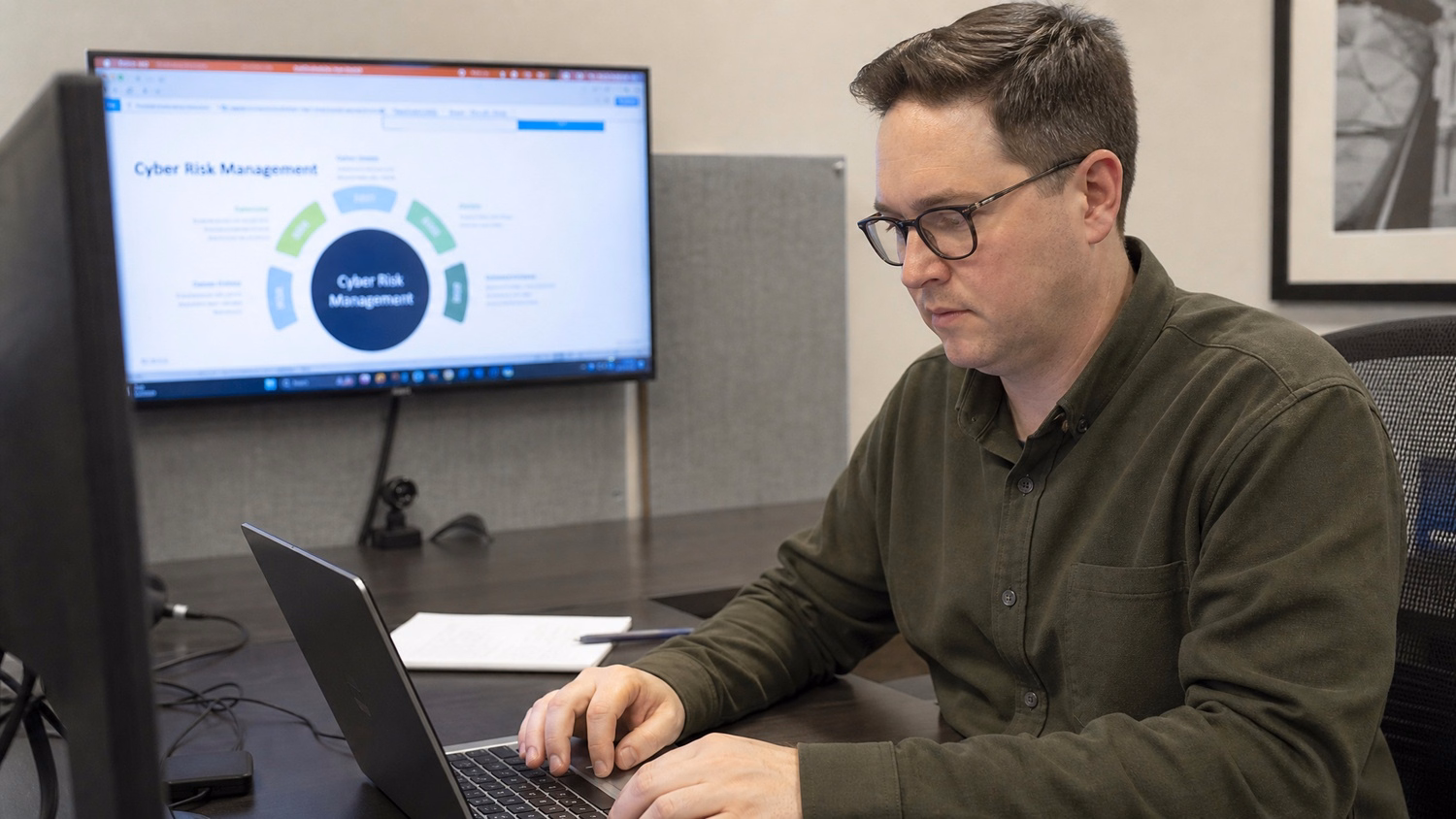 IT professional working at a desk on tasks related to Cyber Risk